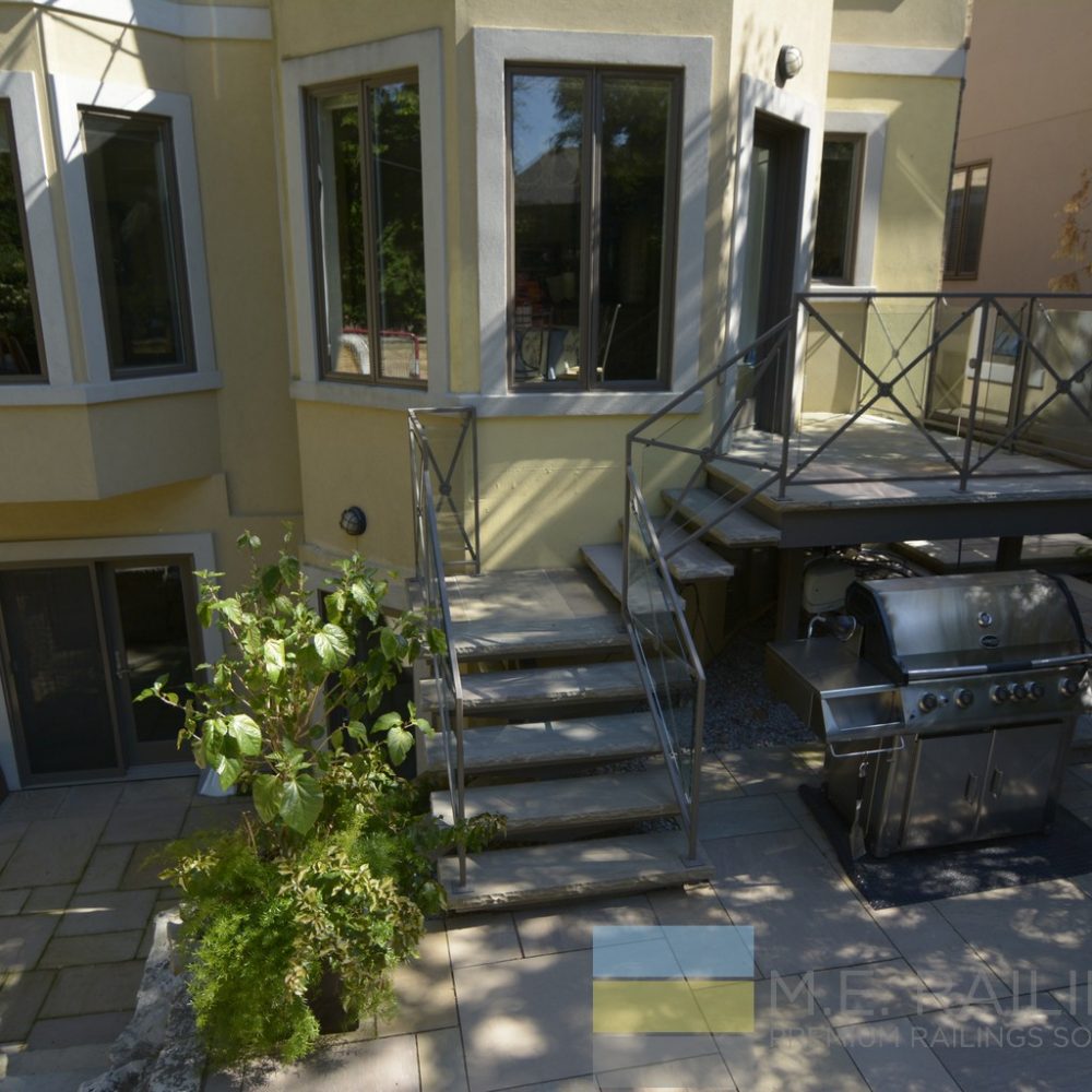 Stainless steel railings with glass and wrought iron steps